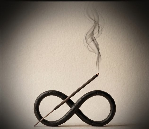 Burning incense stick resting across a black infinity-shaped holder